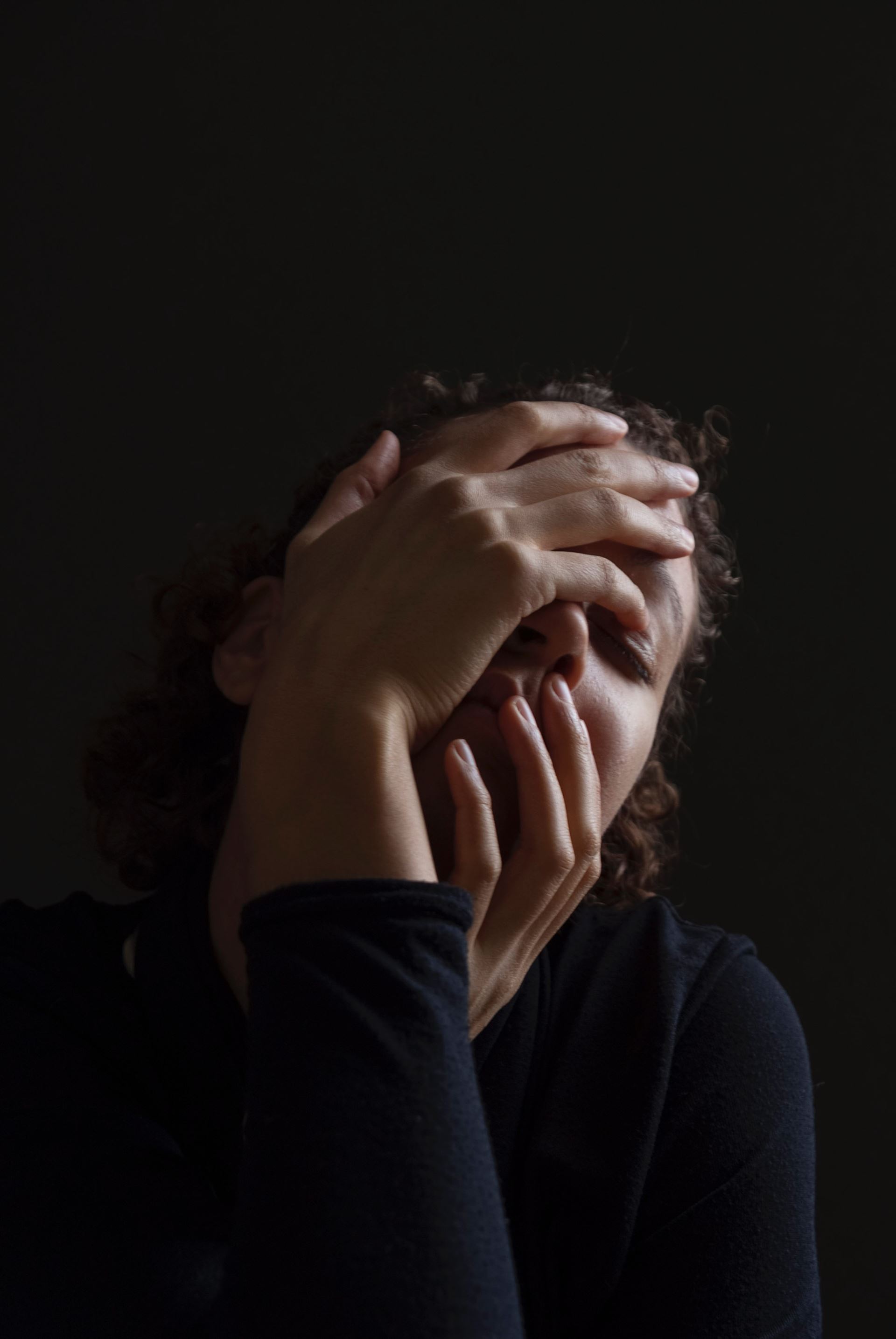 a man sitting in a dark room