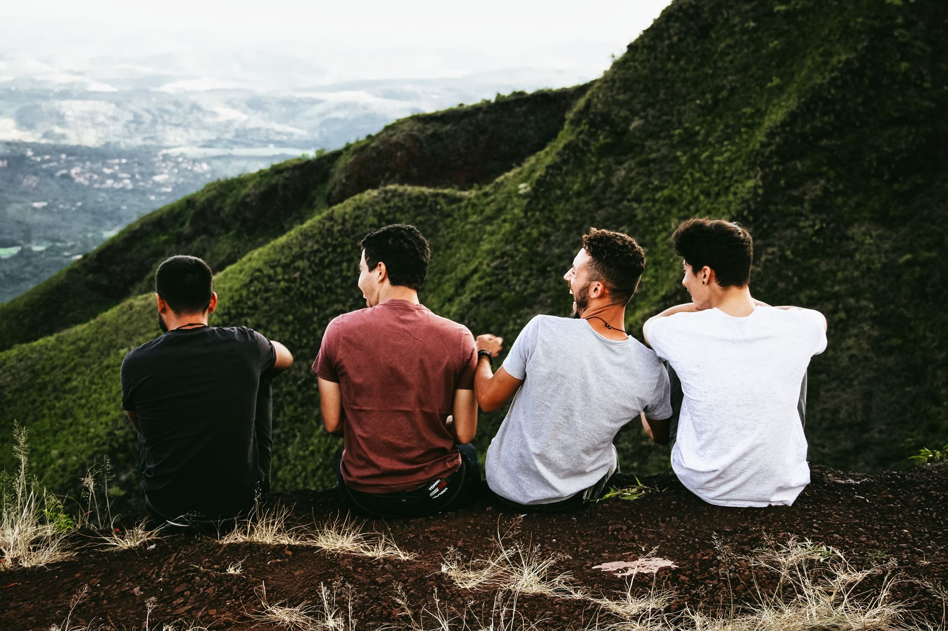 a group of people sitting on top of a mountain